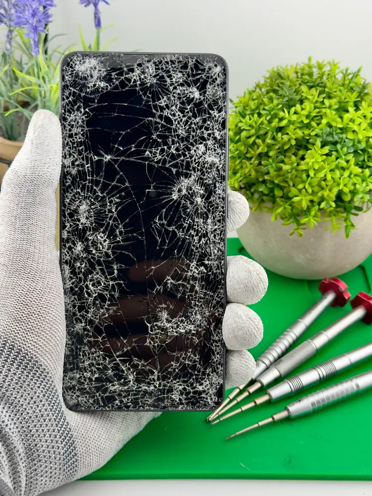 Roztrzaskany ekran telefonu w dłoni